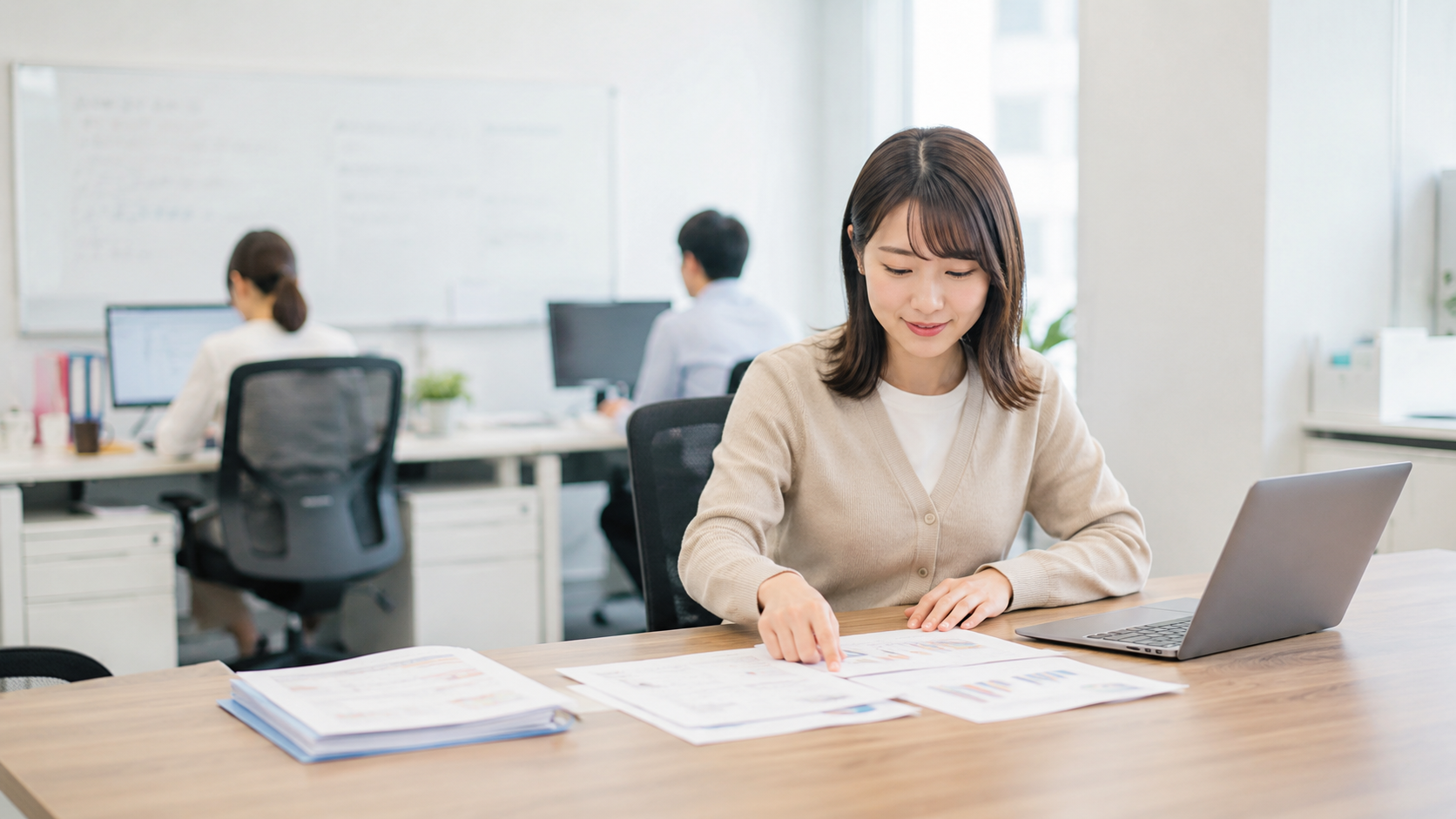 20代後半の日本人女性が小会議室での打ち合わせ場面
