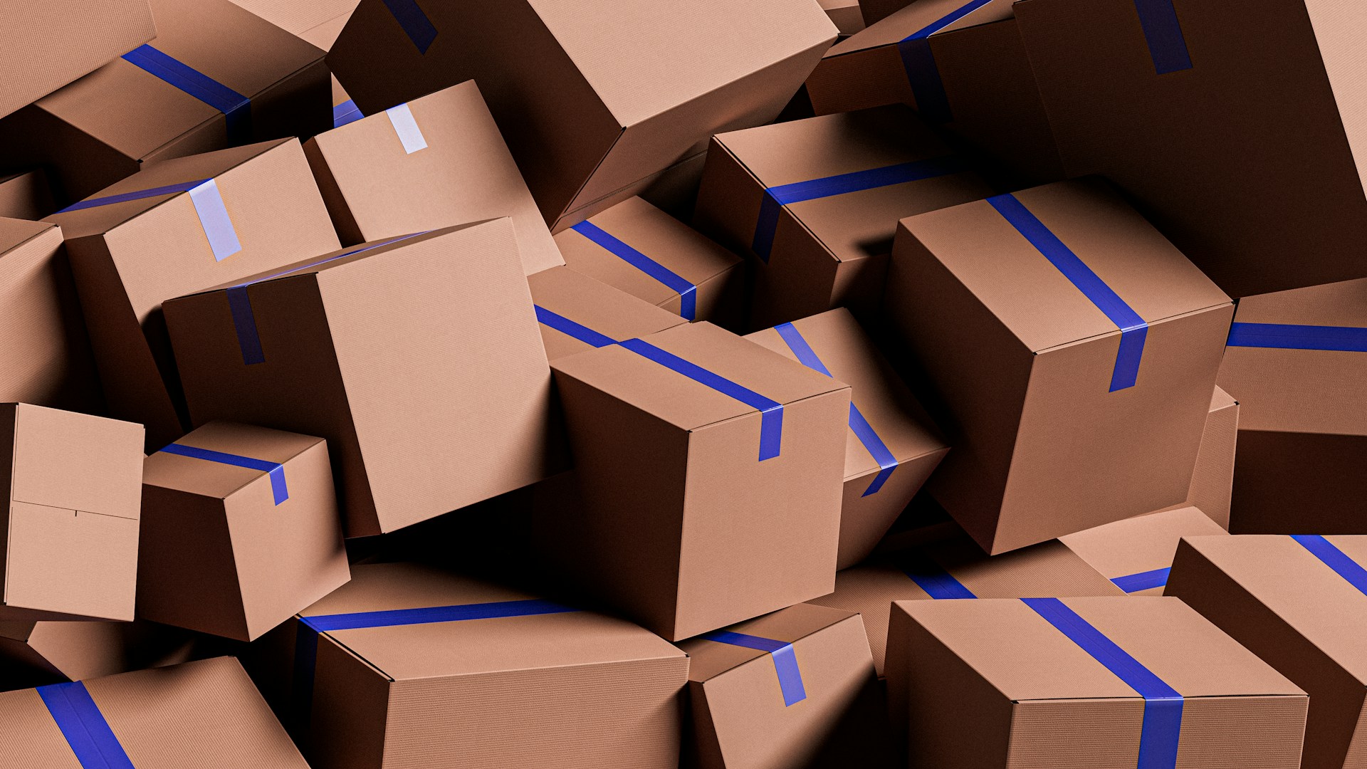 A large pile of brown cardboard boxes with blue tape