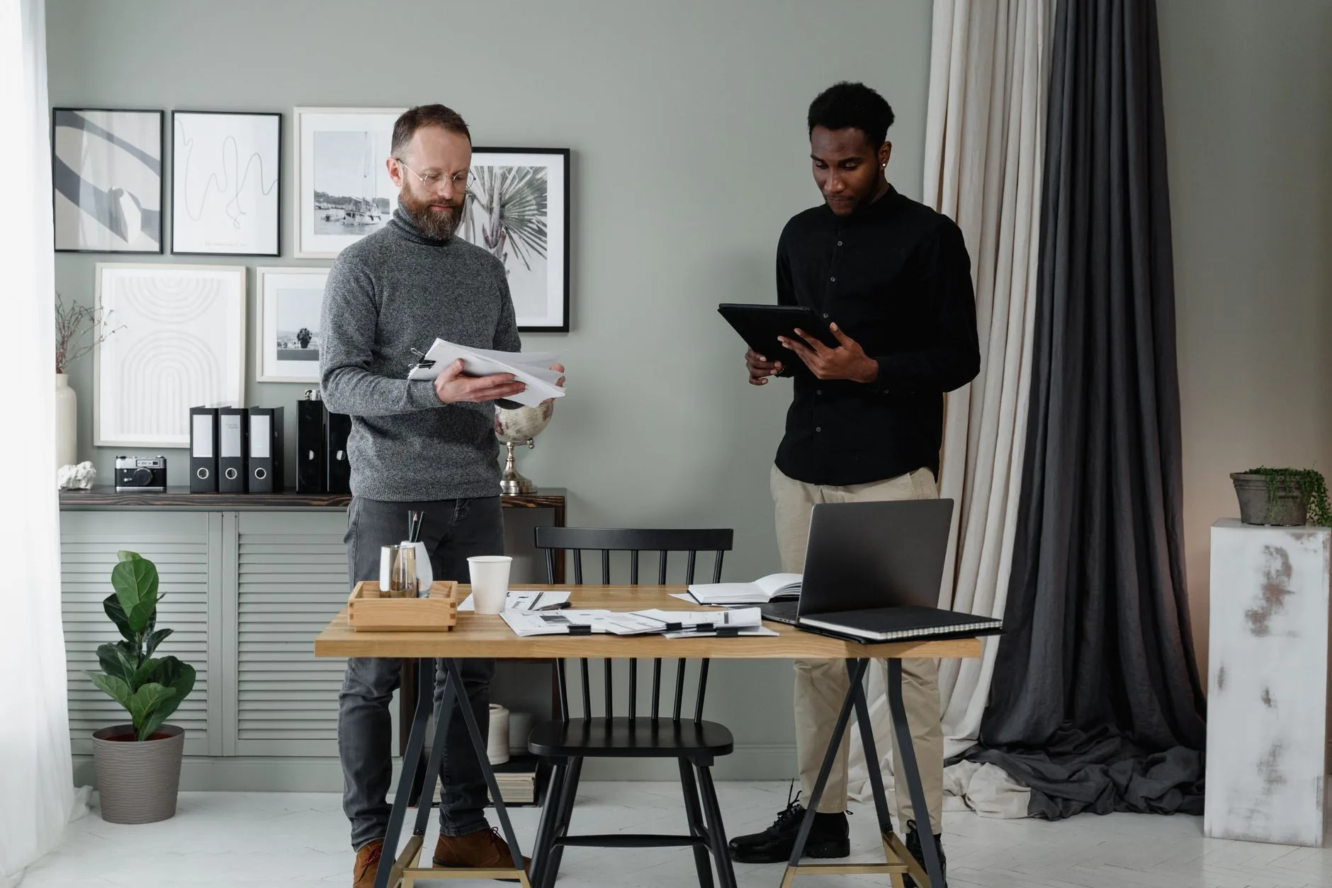 Two professionals discussing documents in a modern and stylish office environment.
