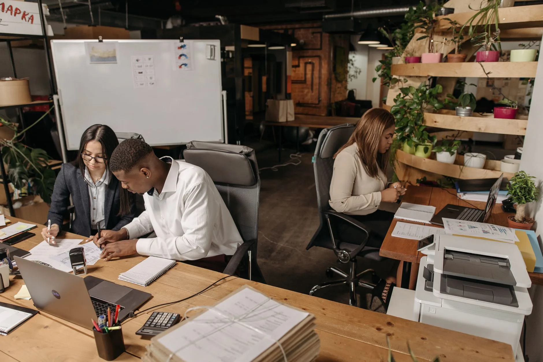 Teamwork in a modern office with diverse colleagues working together on documents.